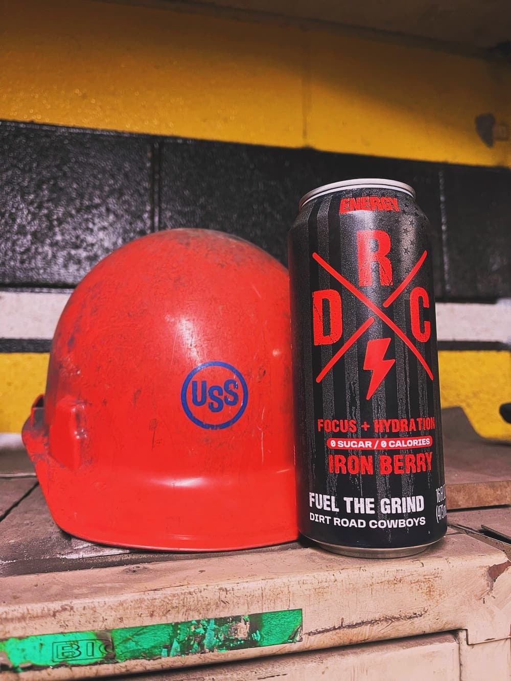 Iron Berry can beside a red hard hat marked USS